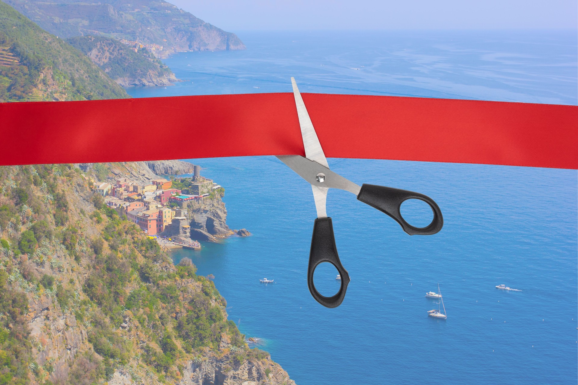 The beginning of the tourist season, the end of quarantine, the opening of the borders of countries. Scissors cut the red ribbon overlooking the sea, the coast of the village of Vernazza, Italy